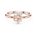 Rose gold ring with diamond accents on a white background