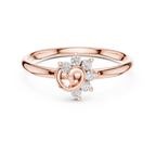 Rose gold ring with diamond accents on a white background