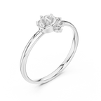 Silver ring with a heart-shaped center stone and smaller stones on a white background
