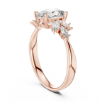 Rose gold ring with oval and marquise cut clear gemstones on white background