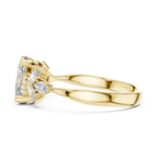Yellow gold ring with split band and cluster of marquise and pear-cut clear gemstones