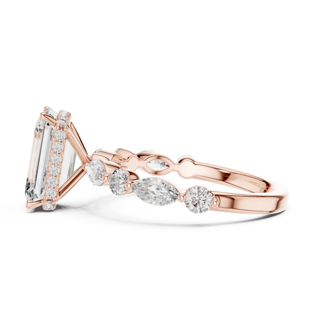 Modern rose gold emerald engagement ring with sparkling side stones