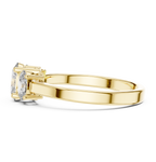 Yellow gold oval trilogy engagement ring prong setting side detail