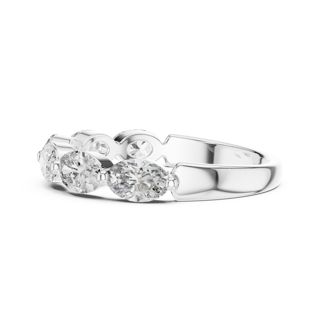 Silver ring with three clear gemstones on a white background