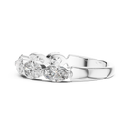 Silver ring with three clear gemstones on a white background