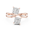 Rose gold ring with two princess-cut diamonds on a white background