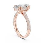 Rose gold ring with a large diamond and smaller diamonds on the band against a white background