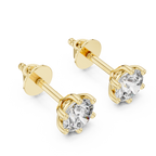 Yellow gold round moissanite diamond alternative stud earrings close up