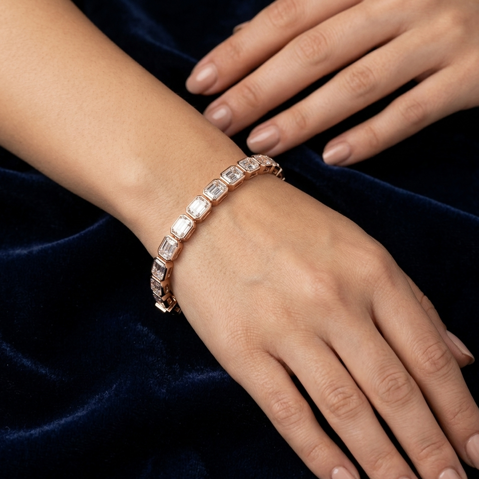 Rose gold bracelet on a wrist with a dark blue velvet background