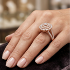 Close-up of a hand wearing a rose gold diamond ring on a blurred background