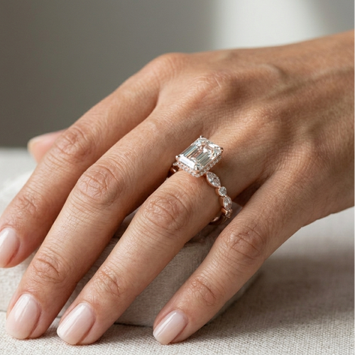 Hand wearing a diamond ring on a neutral background
