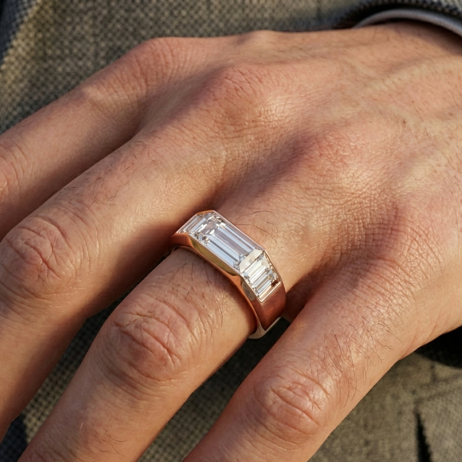 Close-up of a hand wearing a rose gold ring with a diamond on a textured surface.