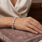 Hand wearing a diamond bracelet on a soft surface