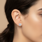 Close-up of a woman's ear wearing a diamond earring against a neutral background