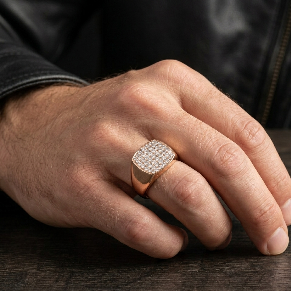 Hand wearing a diamond-studded ring on a wooden surface