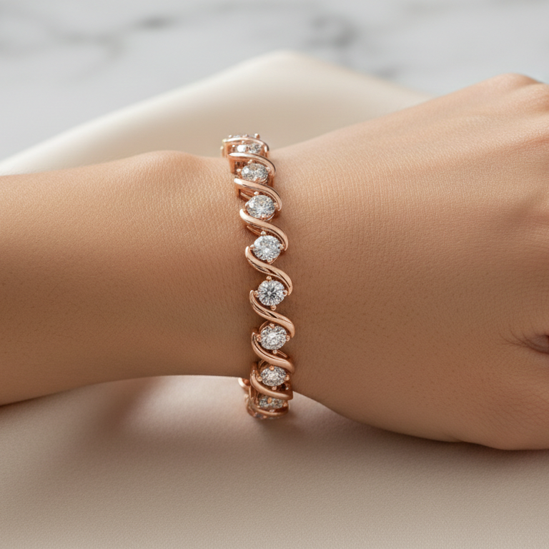Rose gold bracelet with diamonds on a hand against a marble background