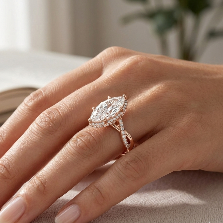 Rose gold diamond ring on a hand with a blurred indoor background