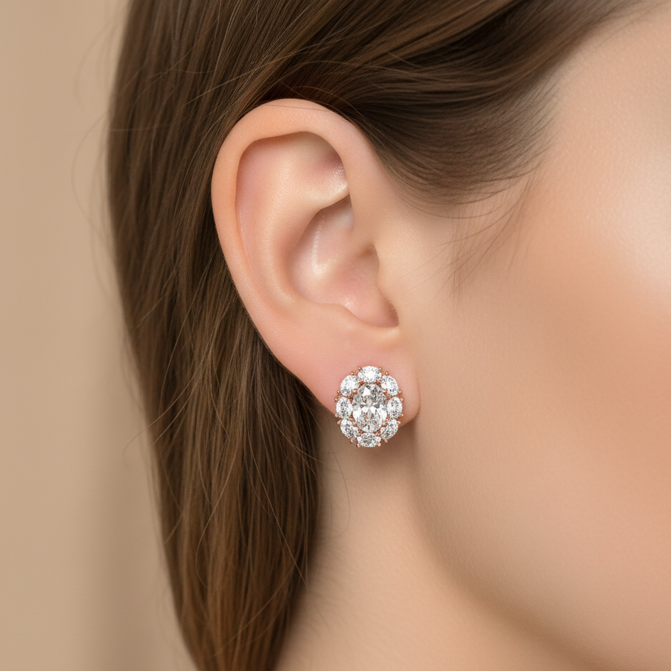 Close-up of an ear wearing a sparkling silver earring against a neutral background