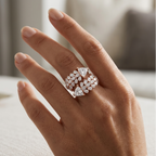 Hand wearing a diamond ring with a blurred background