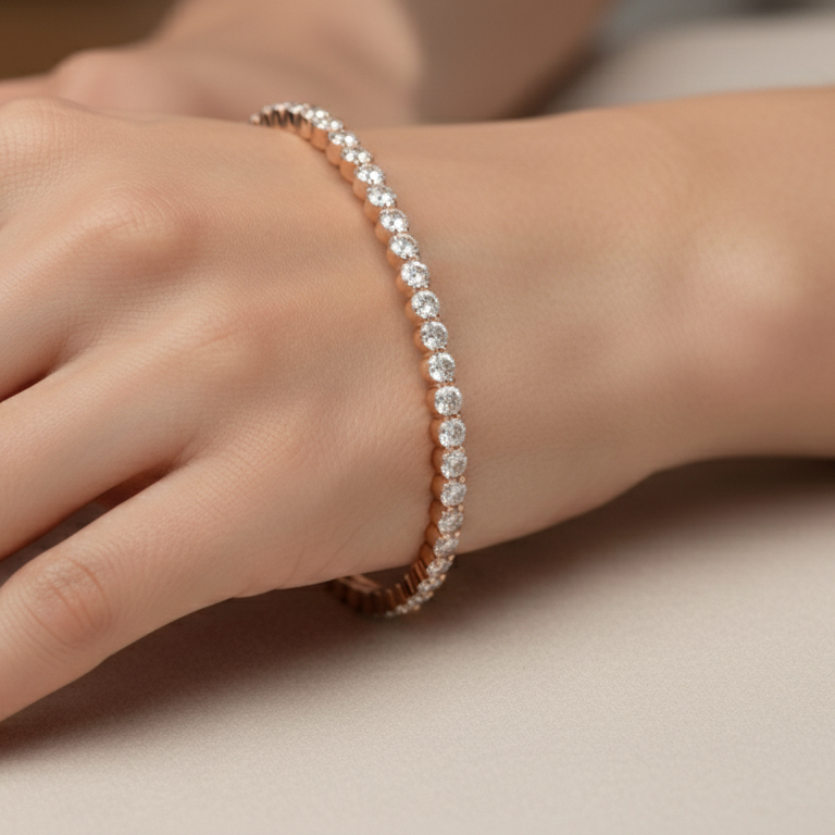 Hand wearing a delicate bracelet on a neutral background