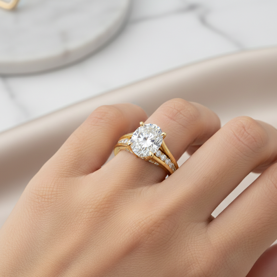 Gold ring with a large diamond on a hand against a neutral background