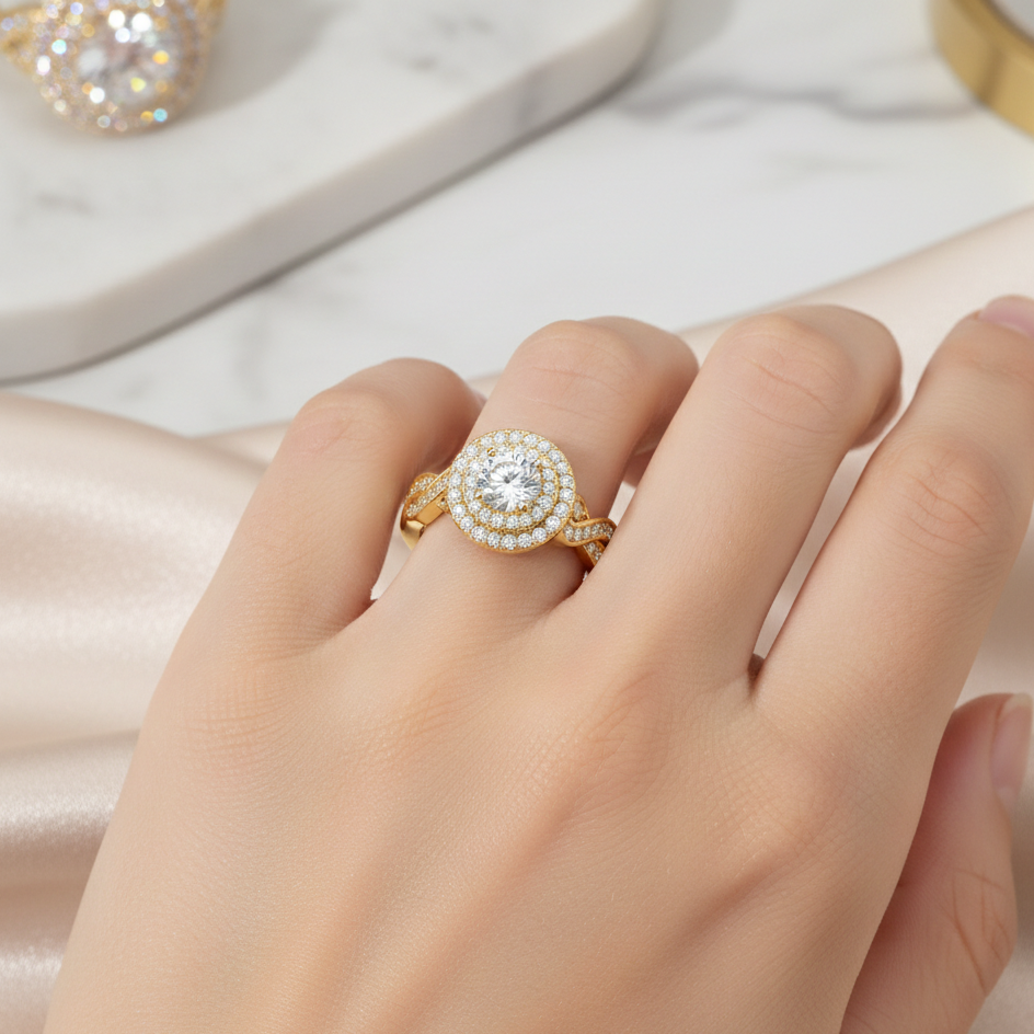 Gold ring with a diamond on a hand against a soft pink background
