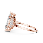 Rose gold ring with pear-shaped diamond on a white background