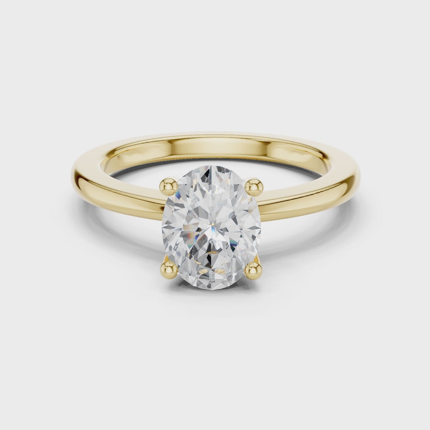 Full rotation yellow gold oval ring showing elegant prong structure and sparkle