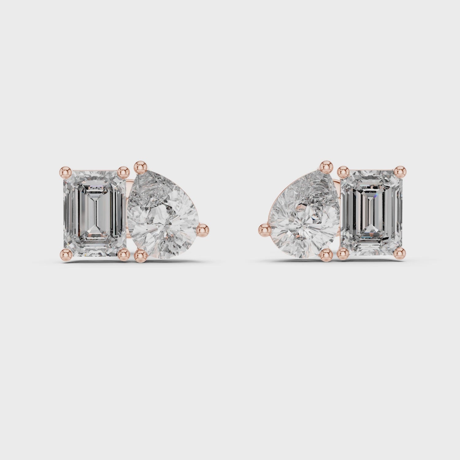 360 degree view of yellow gold emerald and pear moissanite stud earrings