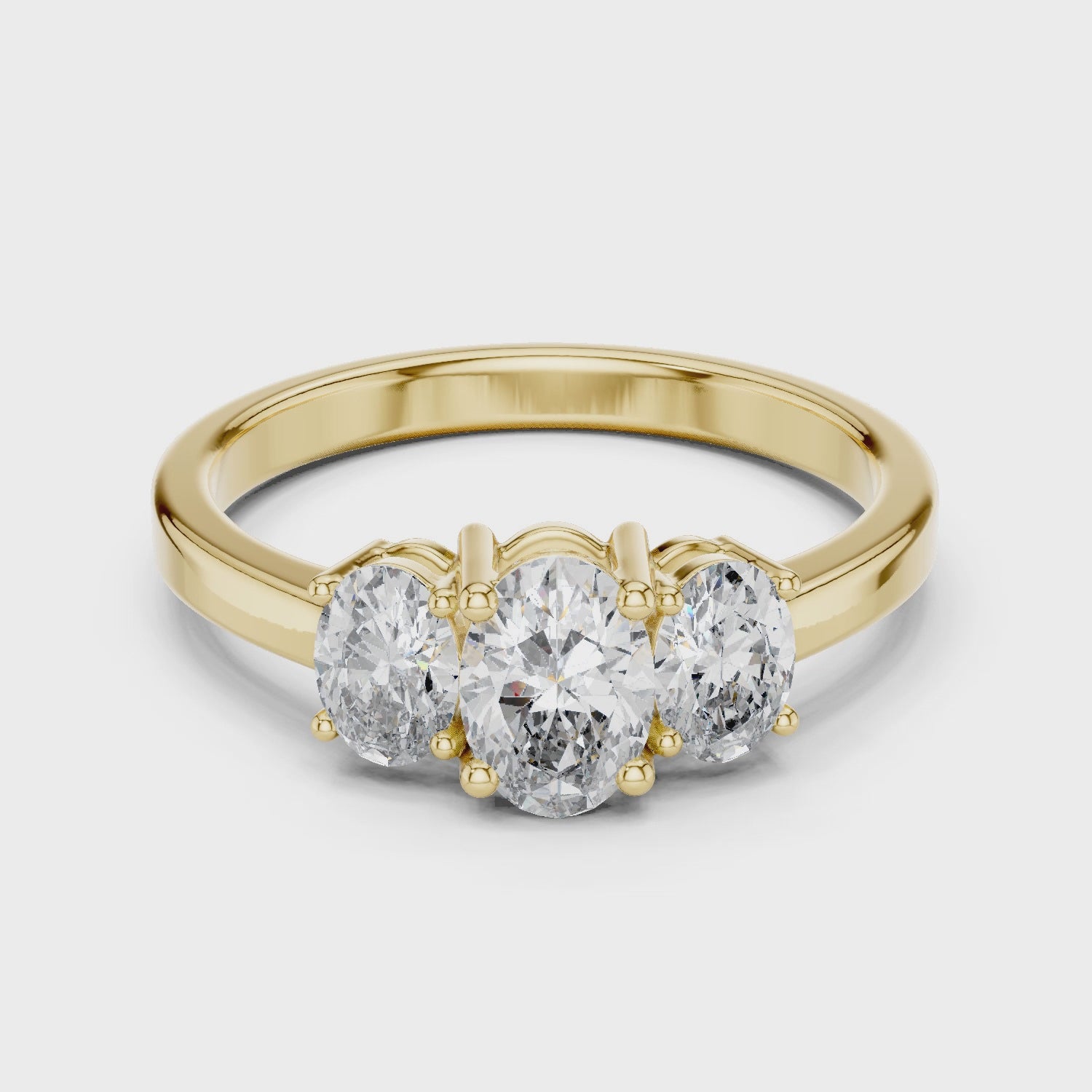 Yellow gold oval trilogy moissanite ring full rotation sparkle

