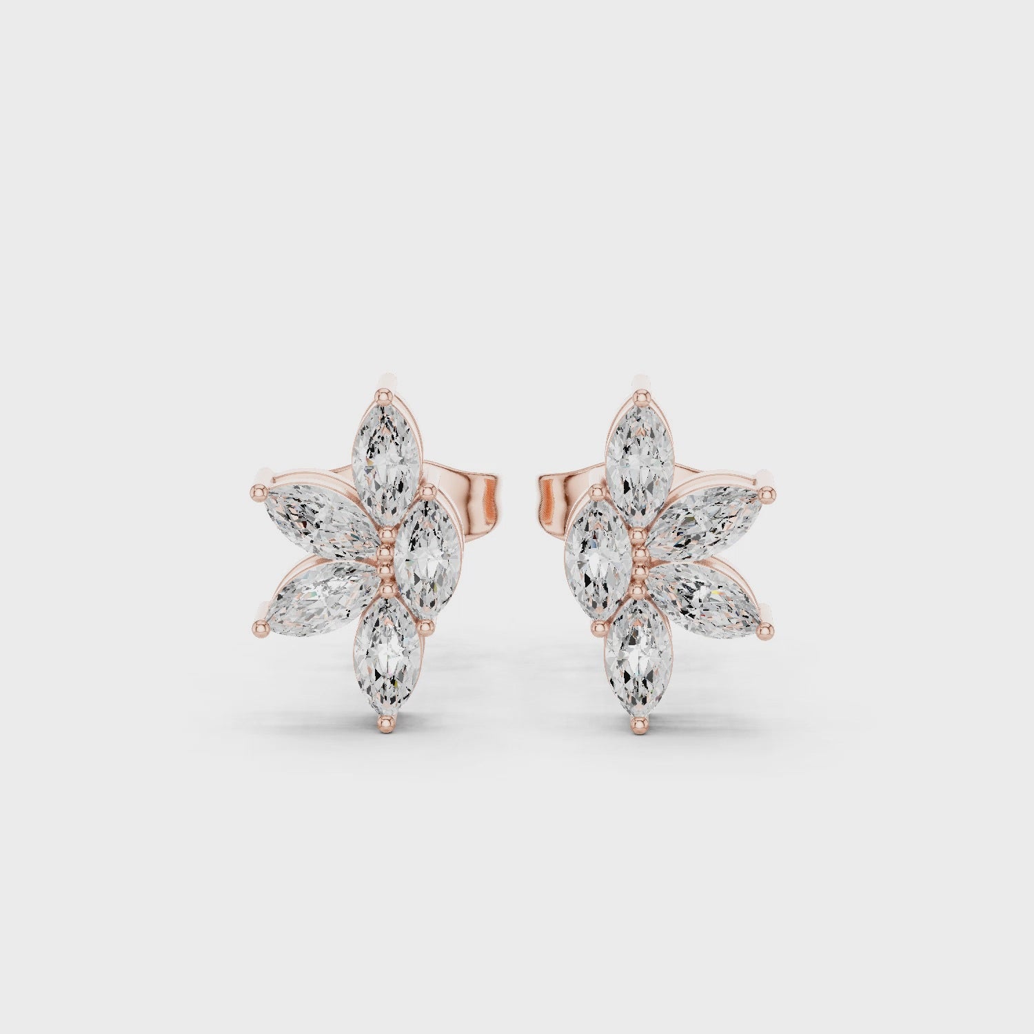 Rose gold floral moissanite stud earrings full 360 rotation view