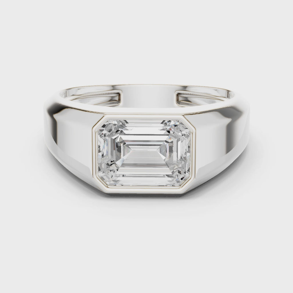 360 degree rotating white gold emerald cut men’s bezel ring showcasing full band detailing