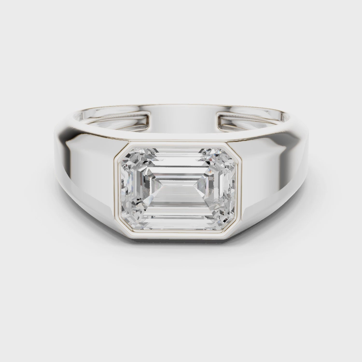 360 degree rotating white gold emerald cut men’s bezel ring showcasing full band detailing