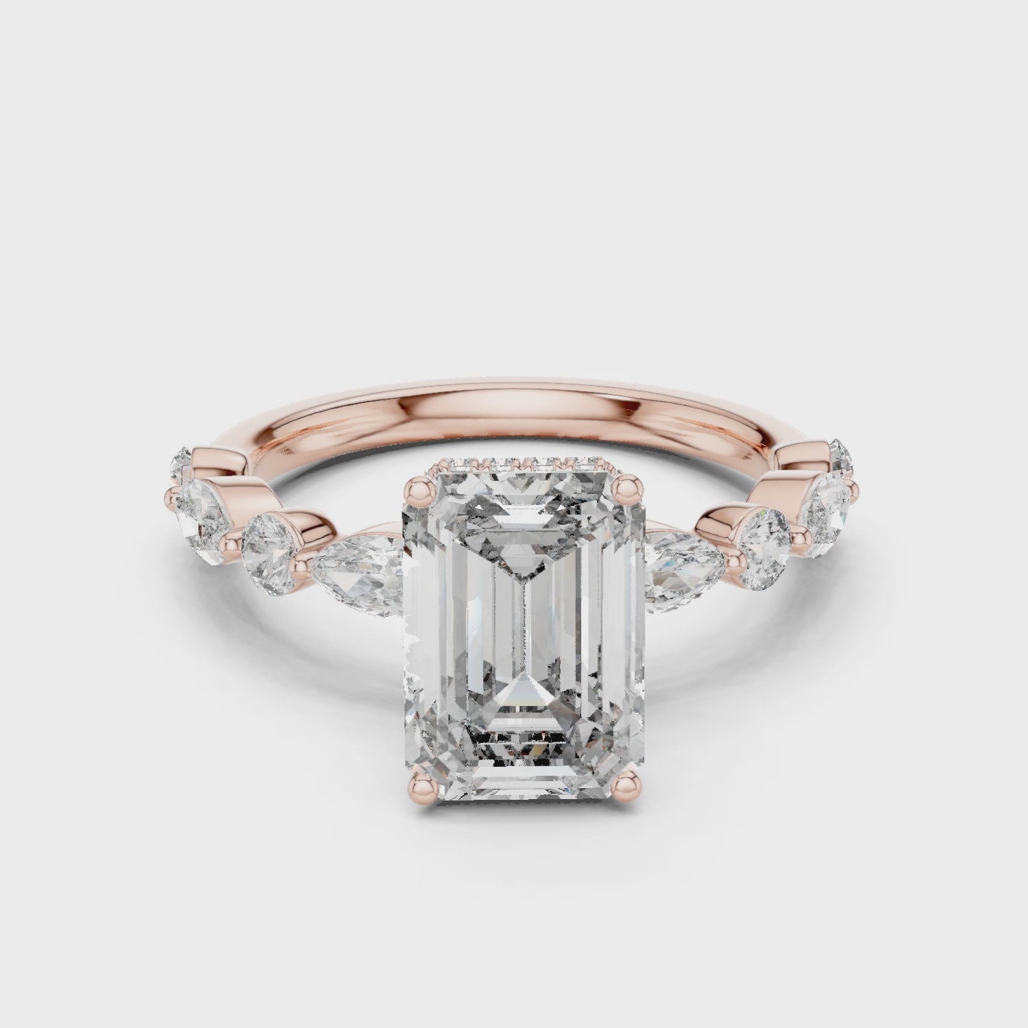 Full rotation rose gold emerald engagement ring highlighting elevated prong structure